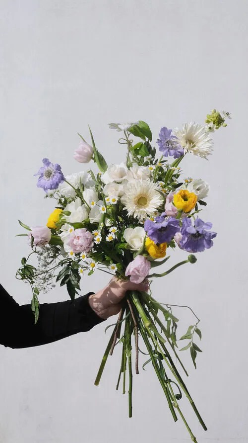 Floral arrangement designed by FLWR London featuring purple, white, green, and yellow flowers Floral arrangement designed by FLWR London featuring purple, white, green, and yellow flowers