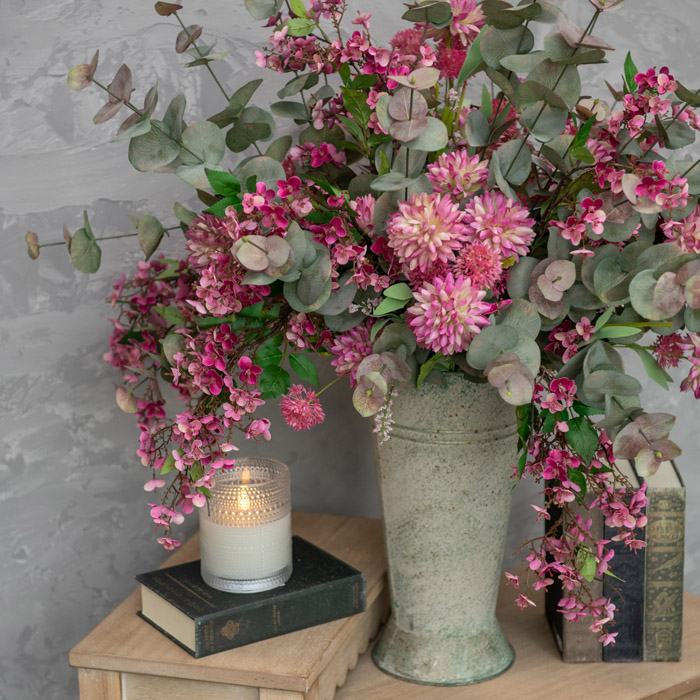 tones of pink and green faux flowers designers ina. vase