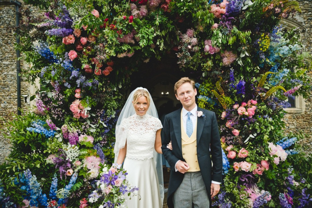bride and groom flower archway above