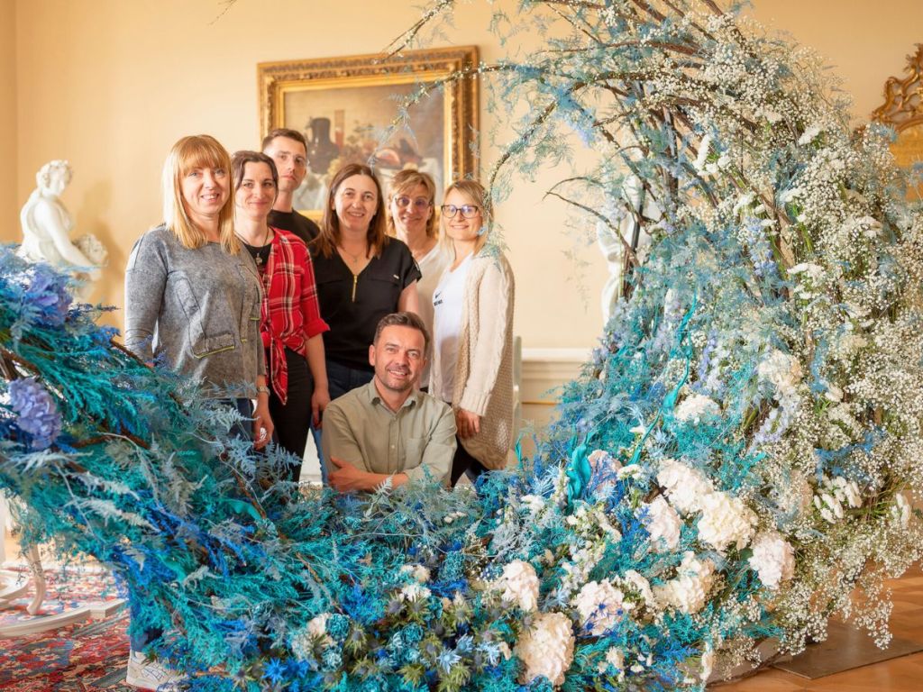 Visitors-pausing-for-a-picture-with-floral-designer-of-the-Storm-floral-Design-Zbigniew-Dziwulski